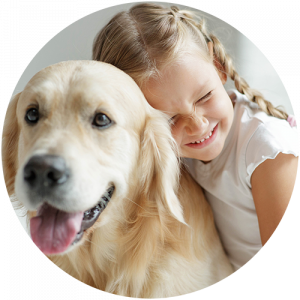 image shows a child smiling with a dog